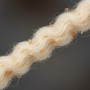 Close-up view of light-colored twisted fibers coated with small, translucent amber-colored droplets – by rugs on net