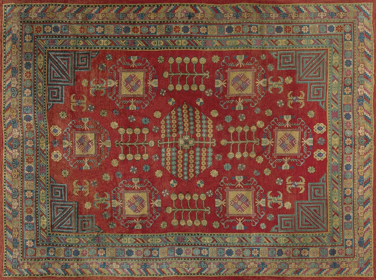 Hand-knotted antique khotan area rug showing a muted rose field and distinct geometric medallions - by rugs on net