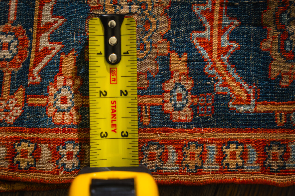 Measuring knot density on a handmade rug with a tape measure