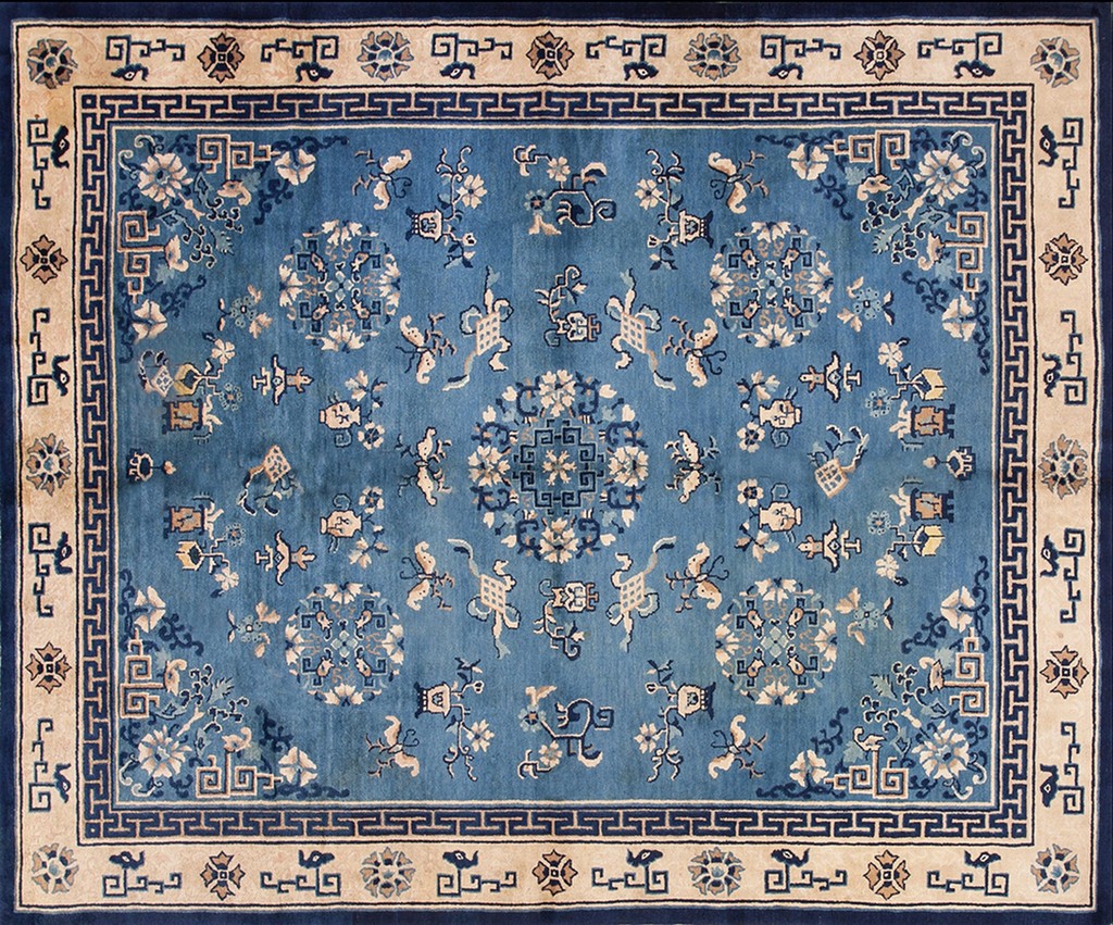 A rectangular, antique blue and cream chinese style wool rug featuring scattered floral medallions and a geometric border by rugs on net.