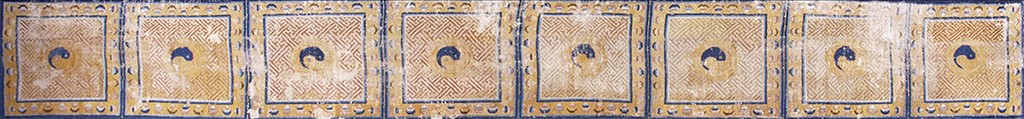 A cropped view of an antique chinese ningxia hallway runner rug featuring repeating square panels with gold geometric fills and dark blue stylized symbols, bordered by blue and yellow crescent patterns by rugs on net.