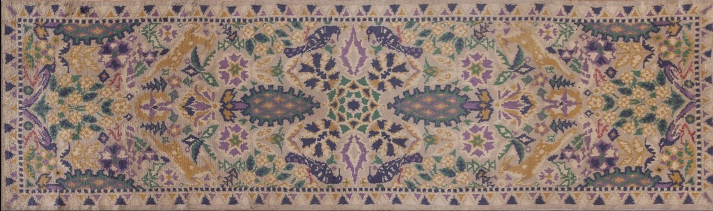 An antique donegal runner rug in an arts & crafts style, featuring a repeating pattern of stylized florals, central medallions, and birds on an ivory ground with accents of purple, yellow, and green by rugs on net.