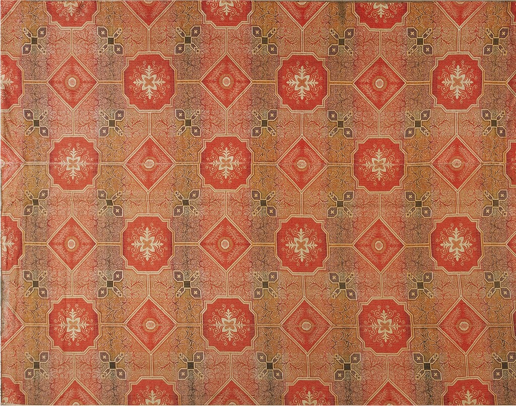 A close-up view of an antique ingrain american flat weave rug with a repeating geometric pattern featuring red octagons and brown-toned diamond fields by rugs on net.