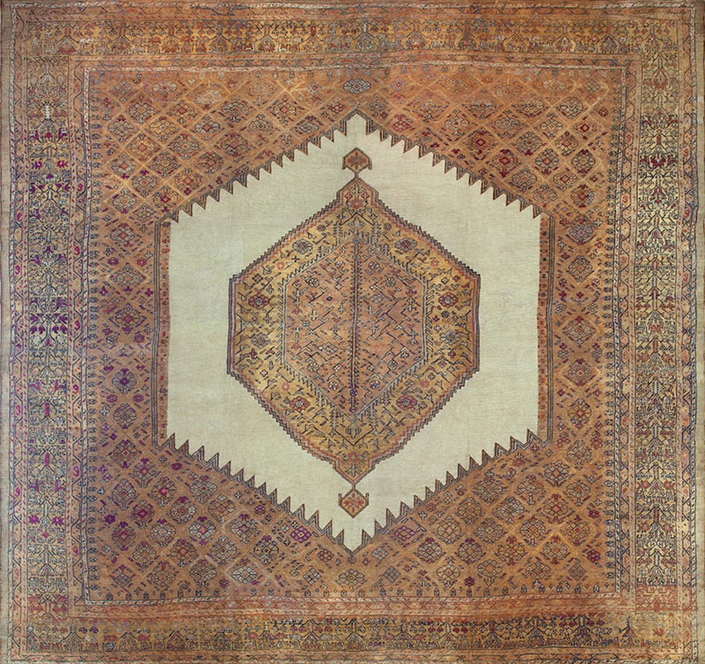An antique, square hand-knotted wool rug featuring a large central ivory/cream field containing an ornate geometric medallion in shades of orange and gold, framed by a serrated border and a richly patterned geometric main field and multi-layered guards - 6 pointed star by rugs on net.