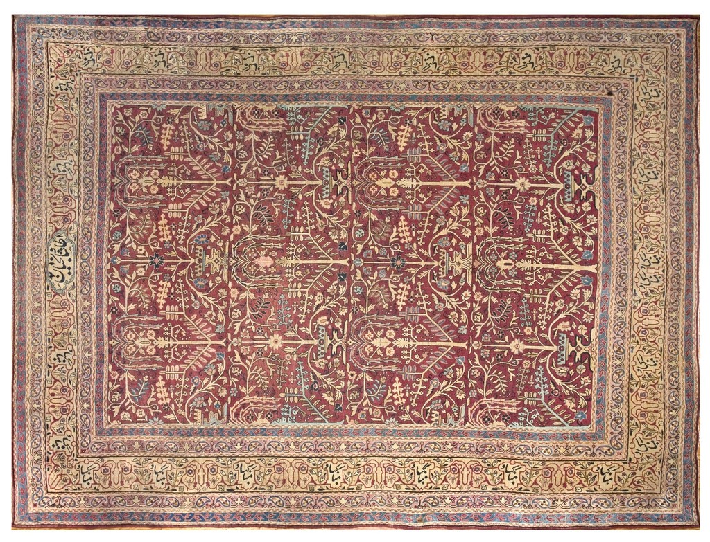An antique kerman lavar room size wool rug with a deep coral field and complex ivory floral pattern, surrounded by a wide, decorative beige border featuring calligraphy, by rugs on net.