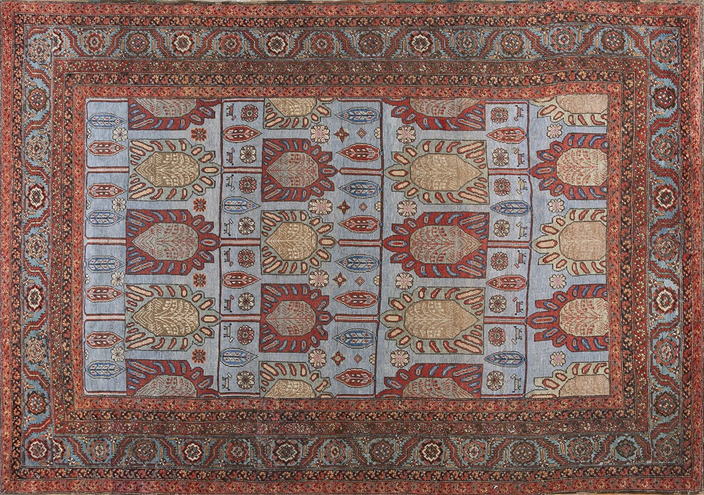 An antique rectangular persian bakshaish rug with a light blue field featuring a large-scale, repeating geometric design of stylized medallions in red and tan, surrounded by a detailed border of reds and blues, by rugs on net.
