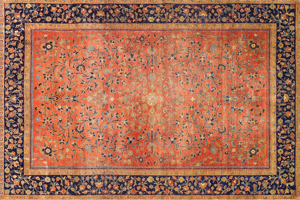 An overhead view of a rectangular antique persian kashan rug with a dominant coral-red field featuring scattered blue floral vines and a wide, dark navy blue border by rugs on net.