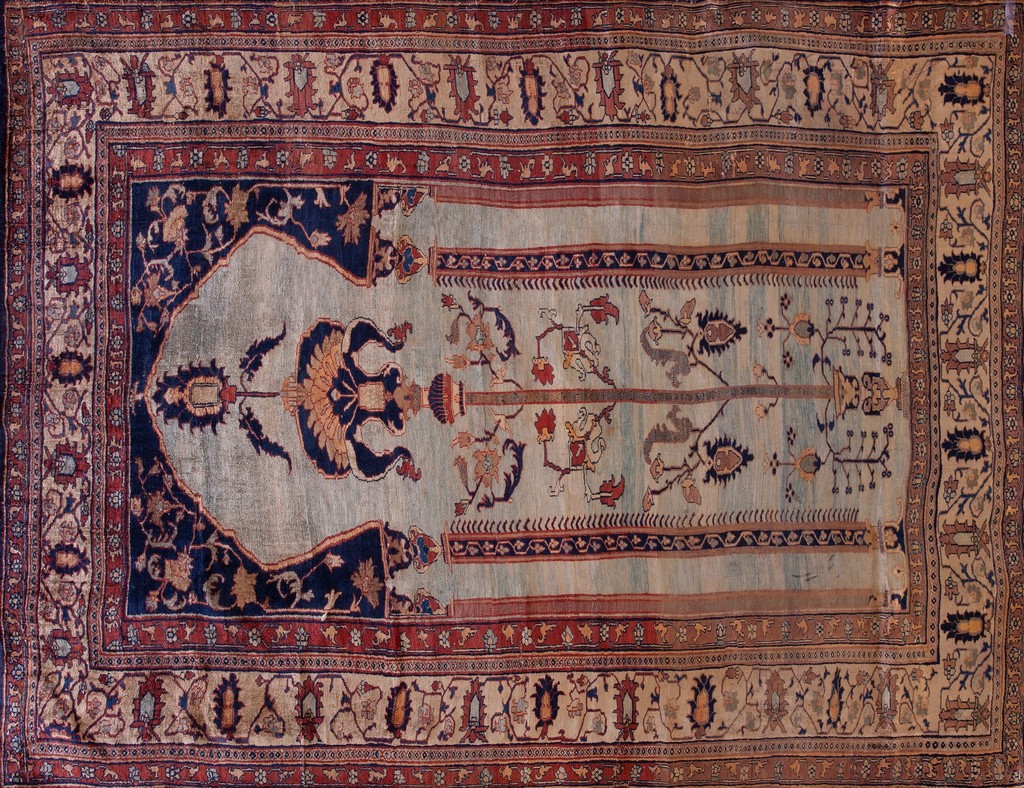 An antique area rugs, small rectangular prayer rug dominated by a light sky blue field featuring dark navy blue floral motifs and stylized tree designs, framed by deep red and beige patterned borders, by rugs on net.