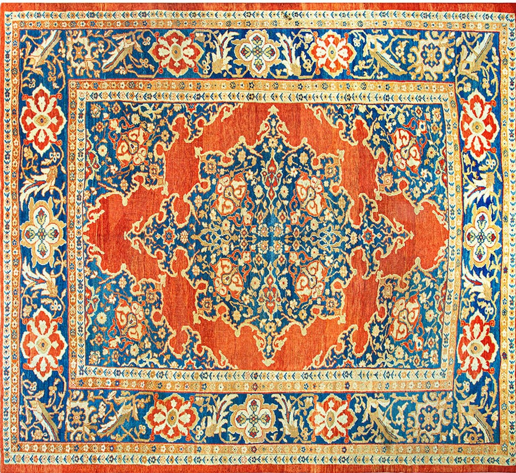 A rectangular, antique persian sultanabad rug featuring a central medallion design dominated by vibrant burnt orange and deep indigo blue with ivory floral accents, all contained within an ornate border by rugs on net.