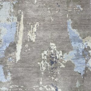 Textured gray rug showing an abstract pattern in patches of light blue and off-white.