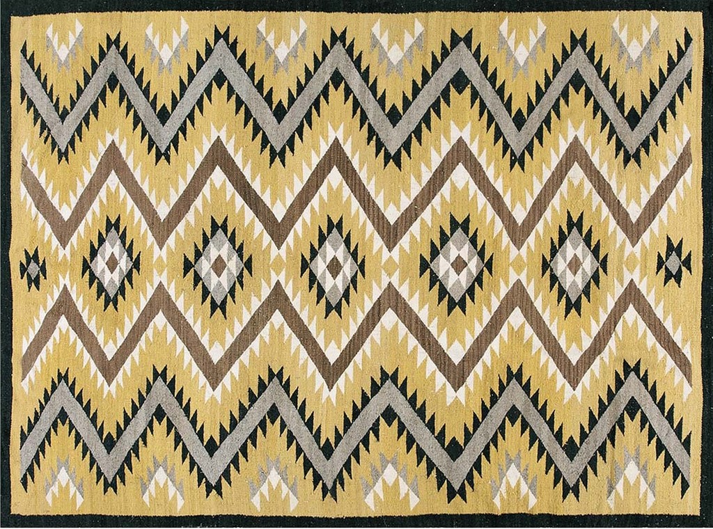 A vintage wool rug with a prominent geometric pattern featuring large zig-zagging chevrons in brown, black, and gray over a mustard yellow background, accented by diamond shapes, by rugs on net.