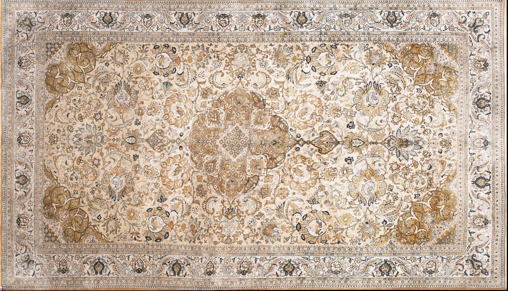 A horizontal, rectangular vintage qum silk persian knotted rug with an all-over floral pattern in shades of cream, gold, and brown. By rugs on net