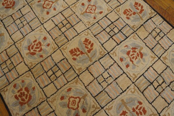 Close-up of a beige rug with repeating burnt orange floral medallions and a grid pattern by rugs on net. By rugs on net