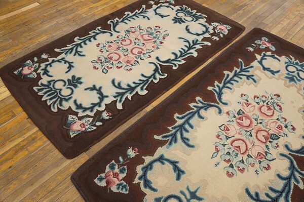 Two brown bordered rugs featuring a central cream field with pink roses and blue foliage, by rugs on net