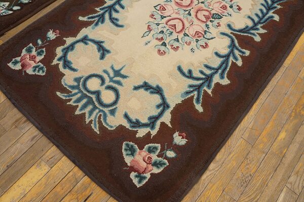 Close-up of a brown floral rug with pink roses and blue accents on a light center, by rugs on net