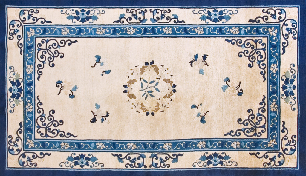 Cream and blue traditional rug with a central floral medallion, ornate scroll corners, and decorative borders by rugs on net