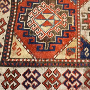 Close-up of a vibrant geometric pattern on an antique rug by Rugs On Net. by Rugs On Net