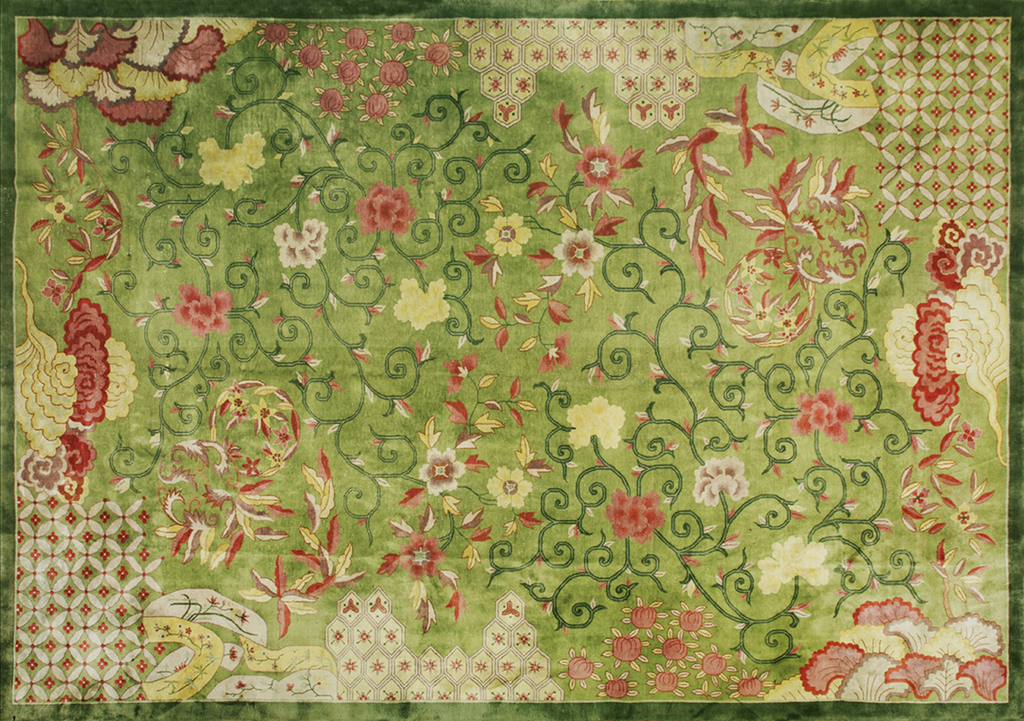 Green area rug with scrolling floral vines in red and yellow, featuring geometric corner details and a dark green border by rugs on net