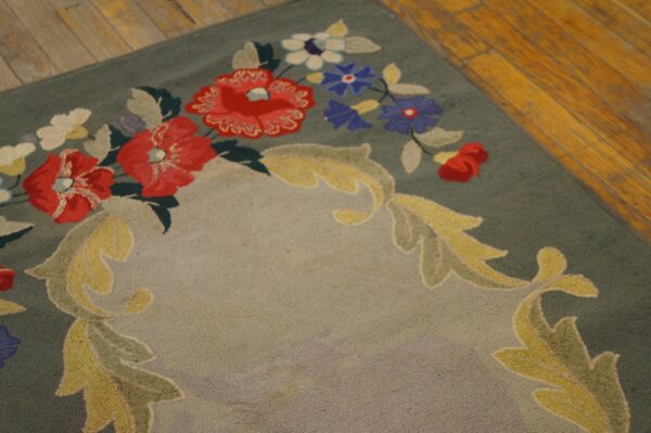 Close-up of a green rug with red, white, and blue floral patterns and yellow scrollwork, by rugs on net