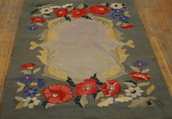 A hooked rug featuring a central medallion framed by red, blue, and white flowers on a sage green field, by rugs on net. By rugs on net
