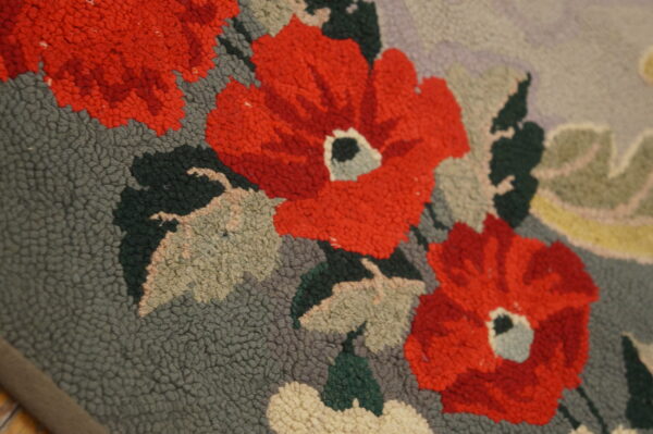 Close-up of red floral pattern on a textured rug by rugs on net