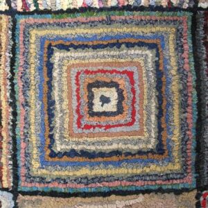 Close-up of a colorful, braided rag rug with concentric square patterns, by Rugs On Net