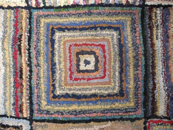 Close-up of a colorful, braided rag rug with concentric square patterns, by rugs on net