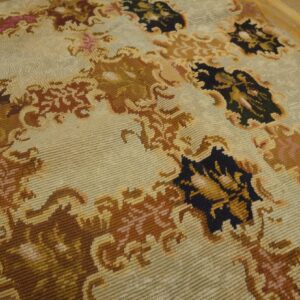 Close-up of a light-colored rug with brown and dark accents, showcasing the texture of the Aubusson Style Rug by Rugs On Net. by Rugs On Net