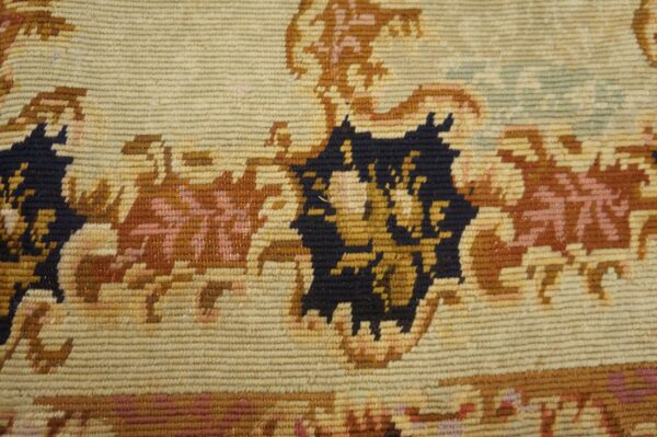 Close-up of a tapestry rug showing beige, brown, and dark blue floral patterns by rugs on net. By rugs on net