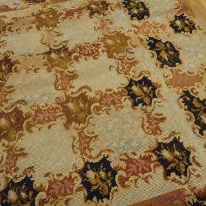 Close-up of a light-colored rug with repeating dark brown and black floral motifs, by Rugs On Net