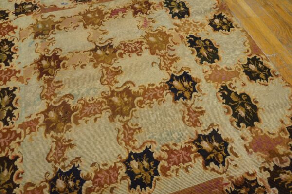 Close-up of a light-colored rug with repeating dark brown and black floral motifs, by rugs on net