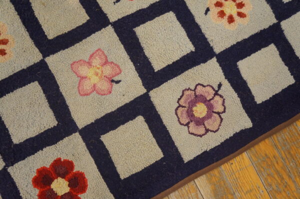 Close-up of a hooked rug featuring a checkerboard pattern with colorful flowers, by rugs on net. By rugs on net