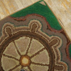 Close-up of a hooked rug featuring a ship's wheel design in earthy tones, by Rugs On Net. by Rugs On Net