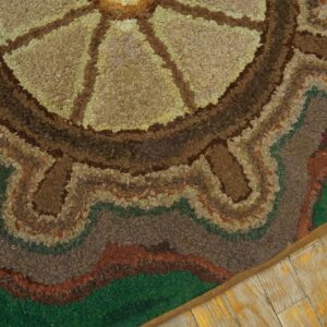 Close-up of a hooked rug featuring concentric circles in earth tones and green, by Rugs On Net