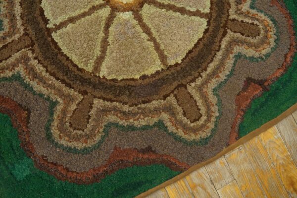 Close-up of a hooked rug featuring concentric circles in earth tones and green, by rugs on net