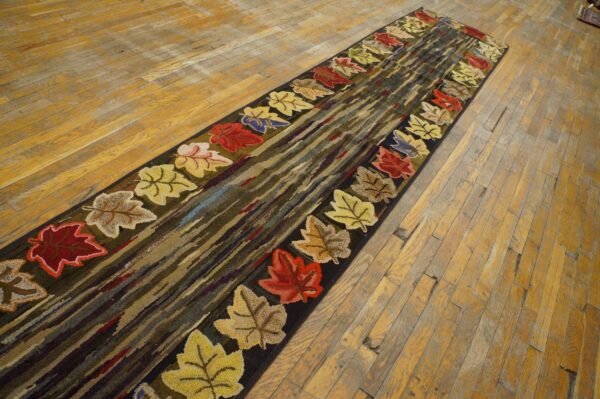 A long runner rug featuring colorful autumn leaves bordering a center of dark, striated colors, by rugs on net. By rugs on net