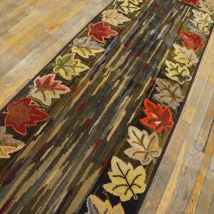 A hook rug runner with colorful autumn leaves bordering a center of abstract vertical stripes, by Rugs On Net. by Rugs On Net
