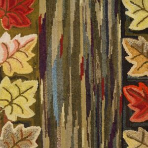 Close-up of a hooked rug featuring colorful autumn leaves flanking a vertical striped center, by Rugs On Net