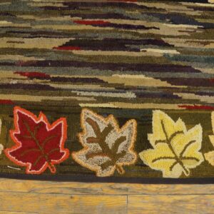 Close-up of a hooked rug featuring horizontal stripes and five distinct maple leaves in various colors, by Rugs On Net. by Rugs On Net