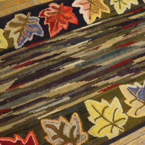 Close-up of a hooked rug featuring diagonal stripes and colorful maple leaves along the border, by Rugs On Net