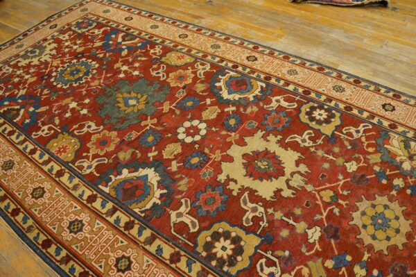 Close-up view of a richly patterned red rug with floral motifs and geometric borders by rugs on net. By rugs on net