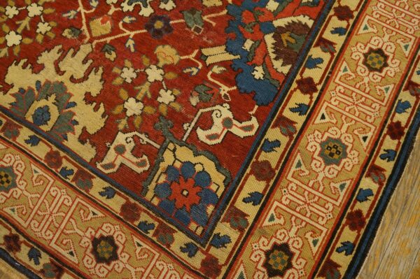 Close-up of a richly colored rug featuring red, cream, and blue geometric patterns, by rugs on net. By rugs on net
