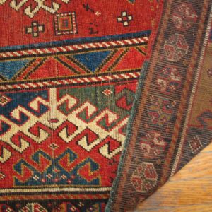 Close-up of a richly colored, geometric rug design, showing the texture and border, by Rugs On Net