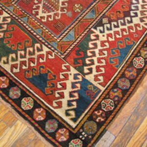 Corner detail of a richly colored geometric rug, possibly Caucasian, by Rugs On Net