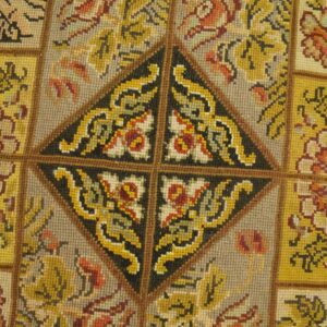 Close-up of a tapestry rug with geometric and floral patterns in yellow, red, and black by Rugs On Net
