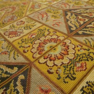 Close-up of a geometric, mustard-yellow patterned rug by Rugs On Net. by Rugs On Net