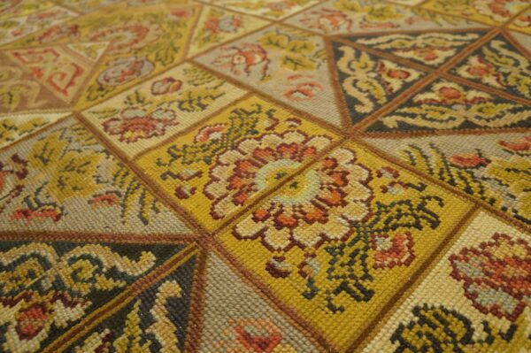 Close-up of a geometric, mustard-yellow patterned rug by rugs on net. By rugs on net