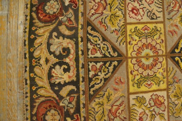 Close-up of a needlepoint rug with floral squares and a dark border, by rugs on net