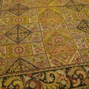 Close-up of a tapestry rug with a geometric patchwork design in gold, red, and grey tones, by Rugs On Net. by Rugs On Net