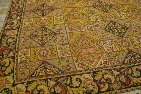 Close-up of a tapestry rug with a geometric patchwork design in gold, red, and grey tones, by rugs on net. By rugs on net